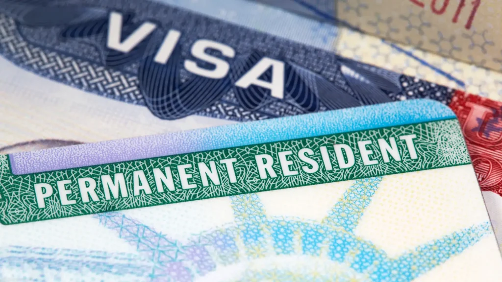 Close-up of a visa and permanent resident card